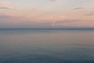 Fototapeta premium Marine Landscape. Clouds at sunset light over the sea.