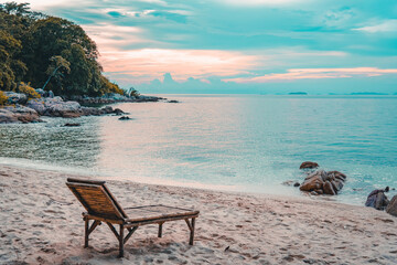 Nature in twilight period which including of sunrise over the sea and the nice beach. Summer beach with blue water and purple sky at the sunset.