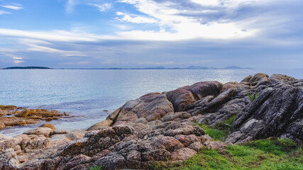 Nature in twilight period which including of sunrise over the sea and the nice beach. Summer beach with blue water and purple sky at the sunset.	

