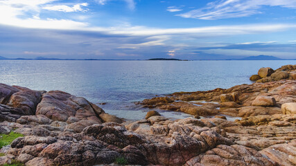 Nature in twilight period which including of sunrise over the sea and the nice beach. Summer beach with blue water and purple sky at the sunset.	
