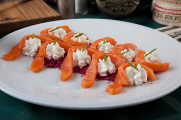 salmon slices with cream cheese and beetroot sprinkles