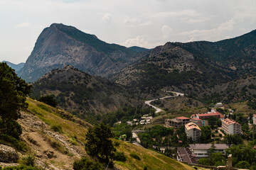 Fototapeta na wymiar The Republic of Crimea. July 15, 2021. View of the Falcon Mountain from the Genoese fortress in the city of Sudak.