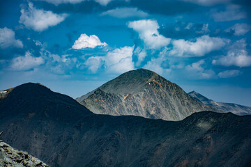 view of the mountain peaks from a height of 3000 meters, with beautiful clouds