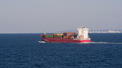 Red container ship underway off Sweden