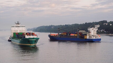 Container ships meet each other on the river