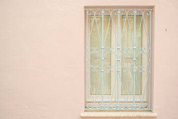 Light blue window on light pink wall background