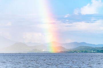 Naklejka na ściany i meble A rainbow over the sea after rain