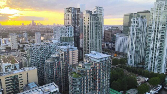 futuristic urban neighbourhood, Skyscrapers in Canary Wharf business hub against bright sunset sky
