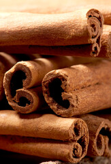 cinnamon sticks on wooden background