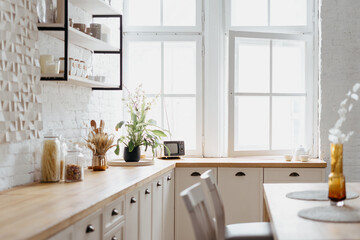 Interior of white kitchen with wooden modern furniture.
