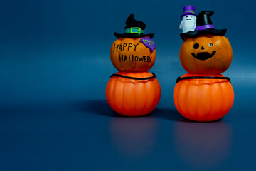 Jack o lantern pumpkin on a dark blue background. Halloween concept backdrop