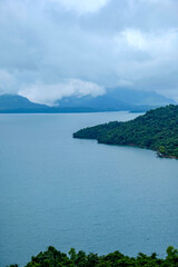 Aerial view of greenery, lake and clouds during the monsoon season at Mulshi near Pune India. Monsoon is the annual rainy season in India from June to September.