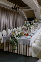 Wedding table with food and decoration for guests by candlelight