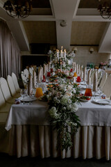 Wedding table with food and decoration for guests by candlelight