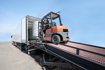 Forklift load pallet with cargo to truck