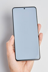 Modern smartphone in hand with clean  white screen