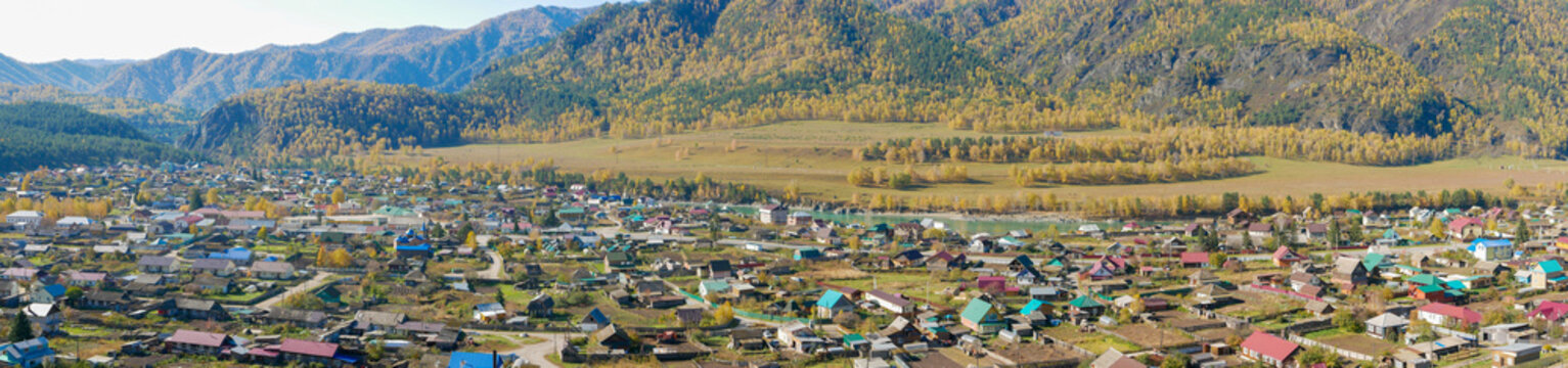 Panoramic view from the mountain to the village of Chemal and the turquoise Katun river. Altai Republic, Russia.