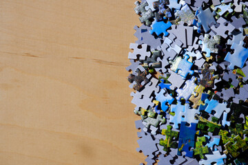 Scattered puzzle pieces on a wooden table