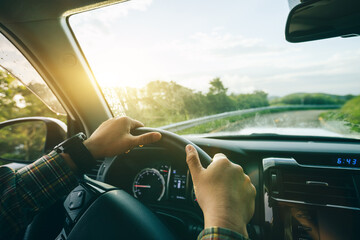 Fototapeta premium People driving car on sunrise mountain road