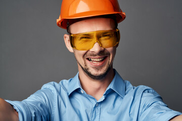 man wearing yellow glasses with orange paint safety work service