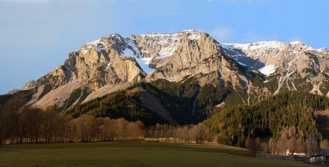 Evening in the Austrian Alps, a beautiful sunset with amazing clouds in the wild. Winter landscape scene from nature, Ramsau, Austria