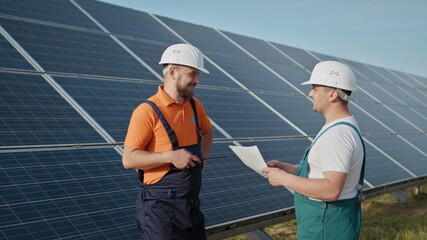 Technician of energy checking the solar cell panels at solar farm energy. Solar energy from Sun...