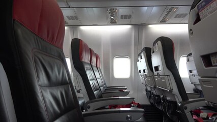 Odessa, Ukraine - 16th of May 2021: 4K Tilt down empty passenger seats on board aircraft
