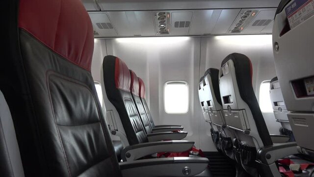 Odessa, Ukraine - 16th of May 2021: 4K Tilt down empty passenger seats on board aircraft
