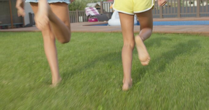 feet of children running to pool