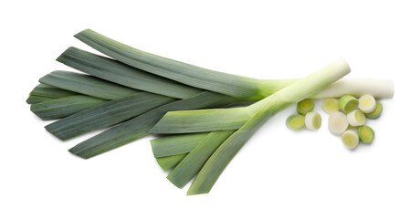 Whole and cut fresh leeks on white background, top view