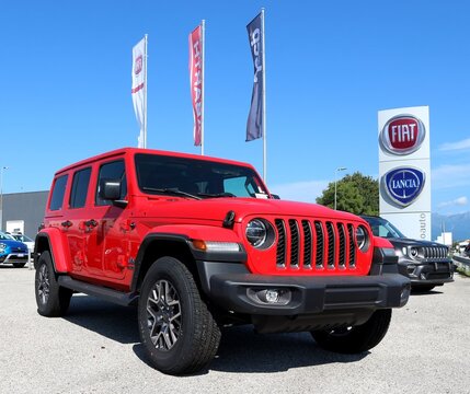 Reana del Rojale, Italy. September 4, 2021. Red Jeep Wrangler Sahara in show outside the Fiat Chrysler Automobiles automaker group dealership of the area.