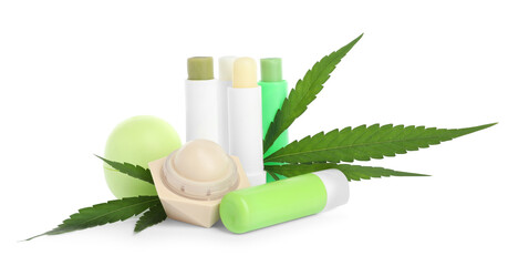 Different hemp cosmetics and green leaves on white background