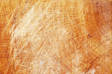 The texture of the brown wood with a dull white scratch fills the frame for the background.
