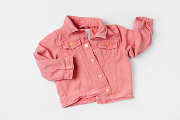 Pink jeans jacket. Baby clothes for spring, autumn or summer on  white background. Fashion kids outfit. Flat lay, top view