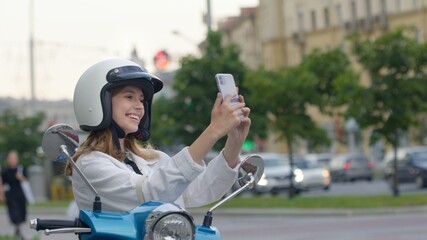 Smiling woman making selfie outdoors