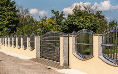 Fototapeta na wymiar Chrome fence gate. Chromium Stainless steel fence
