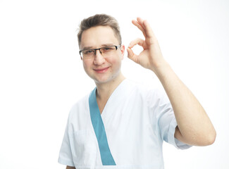 Doctor saying ok with his hand. Young male doctor wearing glasses shows ok sign, body language, medicine concept.