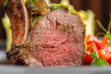 Macro closeup on medium well cooked rack of lamb cutlet