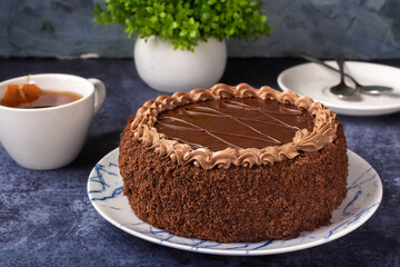 prague cake on a dark background. Chocolate cake on a blue background.