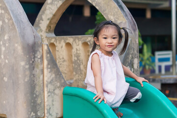 Portrait image of 3-4 years old childhood. Happy Asian child girl playing with the slider bar toy...