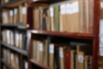 Blurred view of different books on shelves in library