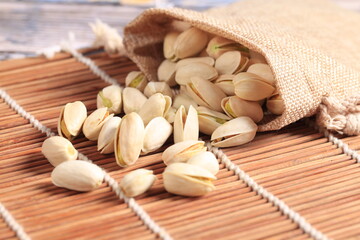 The pistachios are on the wooden board