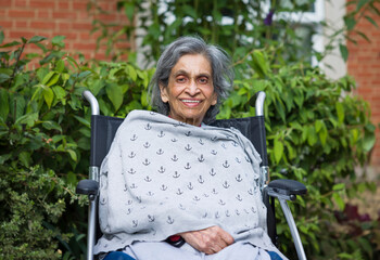 Elderly Asian Indian woman in nursing home, care home or garden