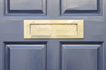 Old letterbox in the door, traditional way of delivering letters to the house, old mailbox