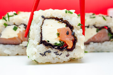 Closeup of smoked salmon, soft cheese and chive California roll