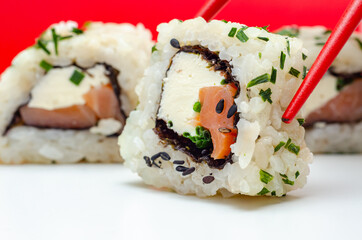 Closeup of smoked salmon, soft cheese and chive California roll
