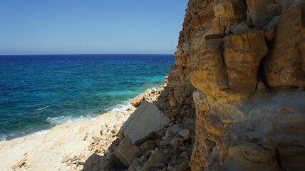 beach and rocks cliff in the Greek island of koufonisi August 2021