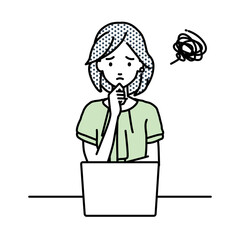 デスクで座ってPCを開いて困っているオフィスカジュアルの女性