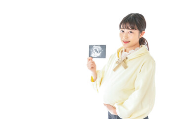 エコー画像を持つ若い妊婦の女性