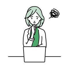 デスクで座ってPCを開いて困っているジャケットの女性